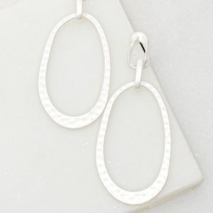 Silver hammered oval hoop earrings.